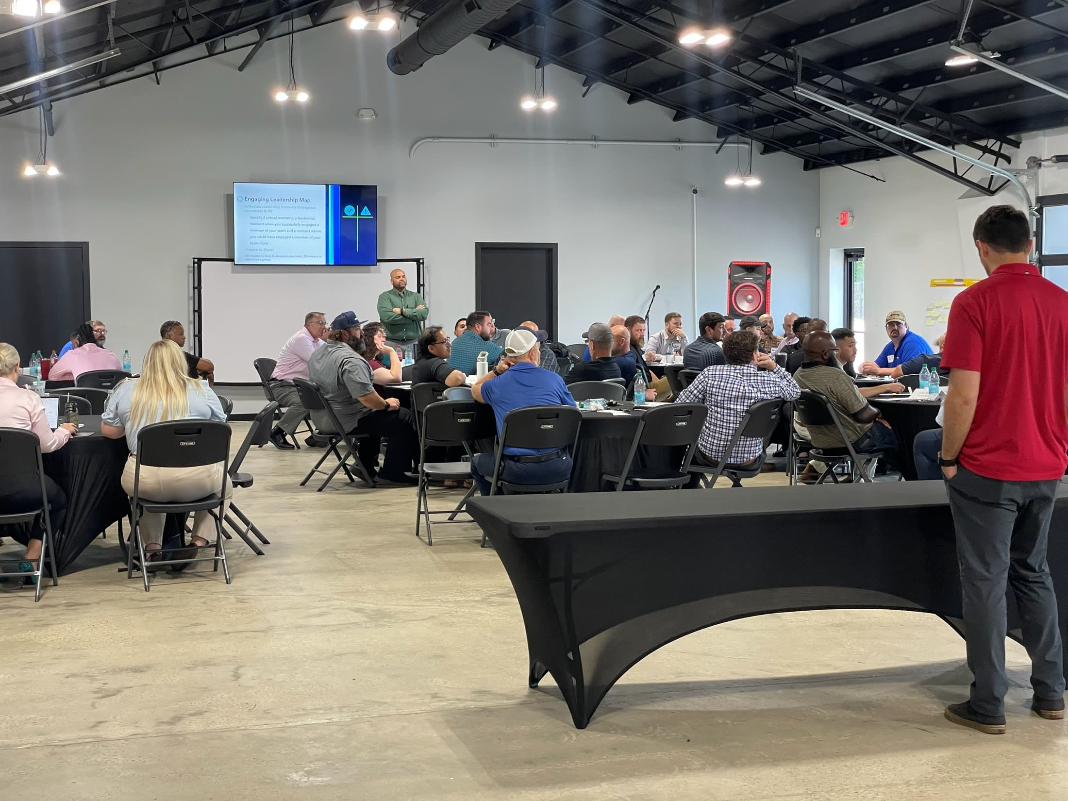 A corporate group mid-session in the event space at Music City Kartplex