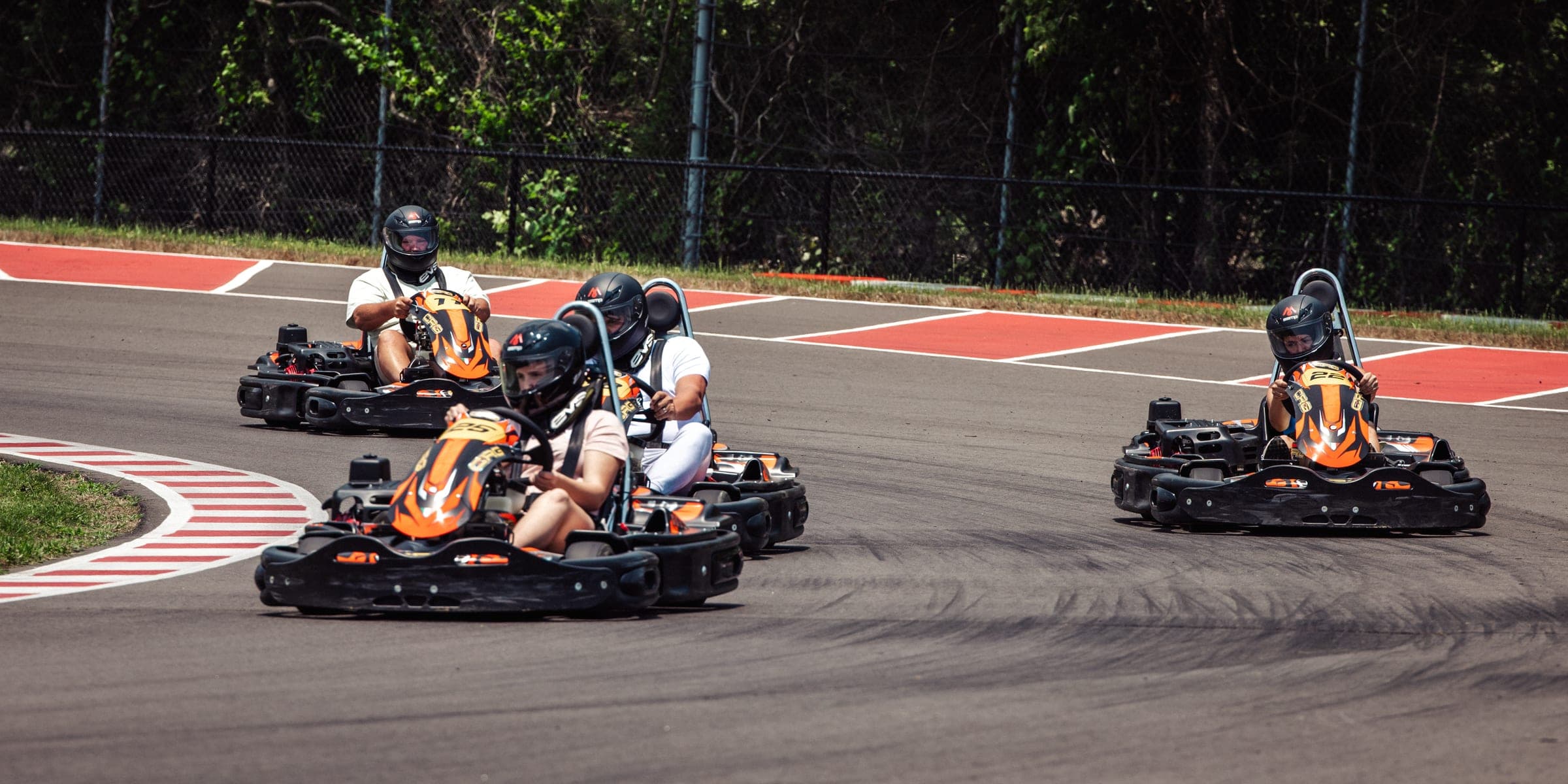 Four rental karts racing through a corner at Music City Kartplex