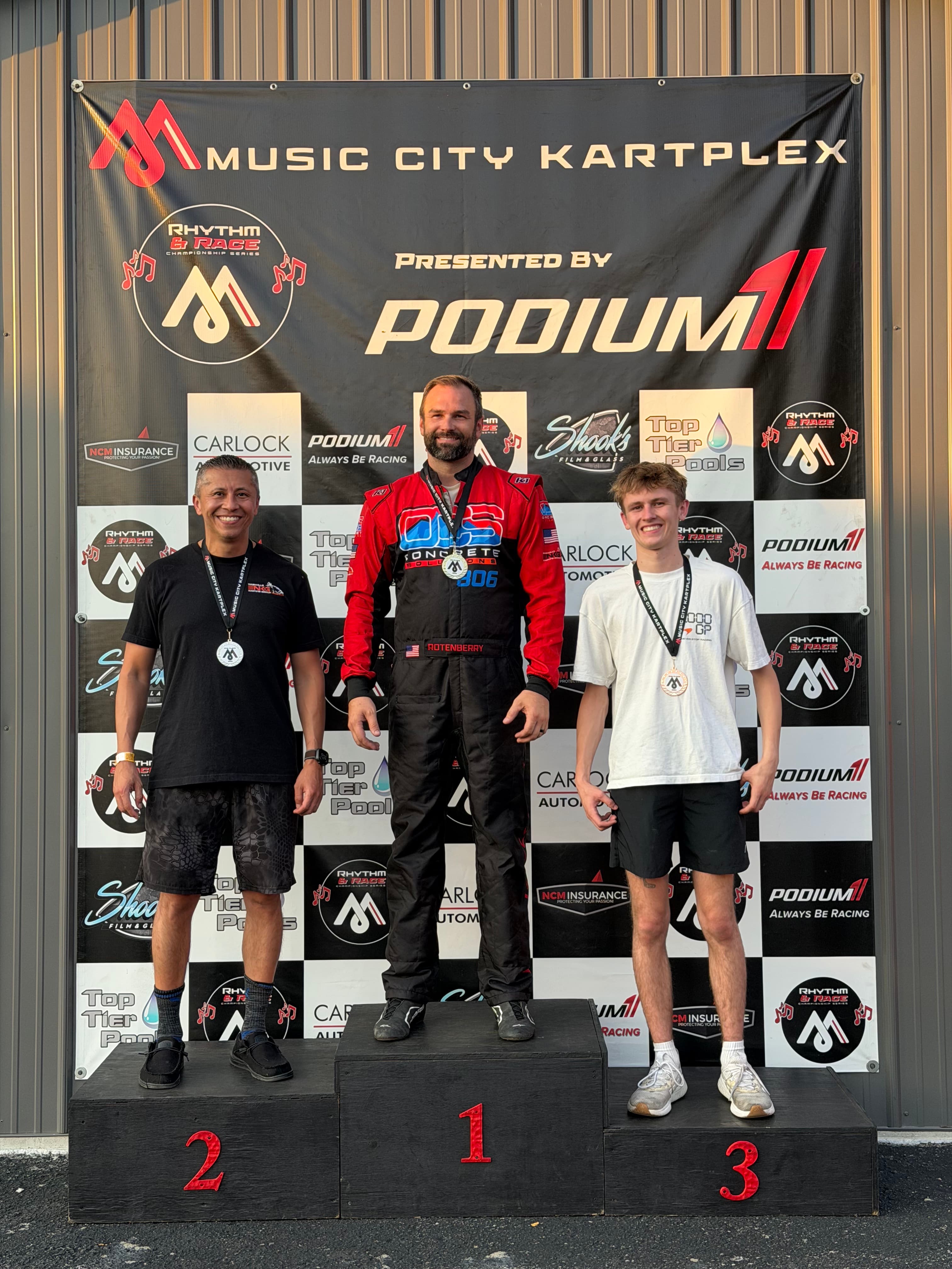 Class winners on the podium with trophies
